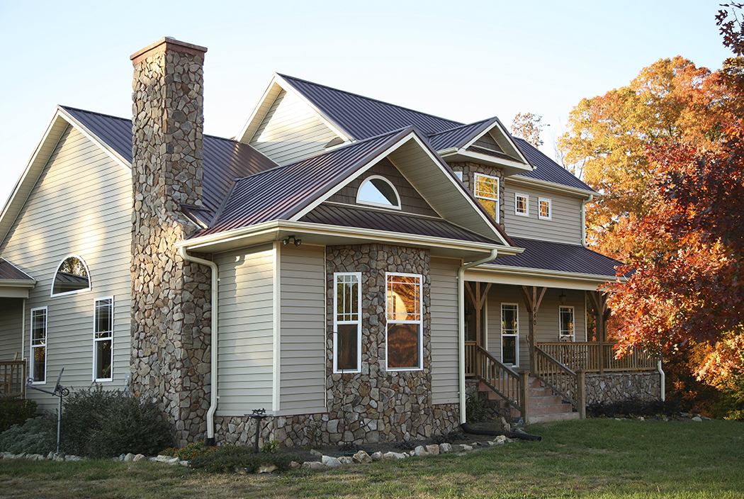 Beige and stone house in the fall