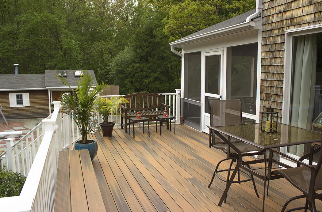 Nicely done, newly renovated deck with white rail and dark wood floor