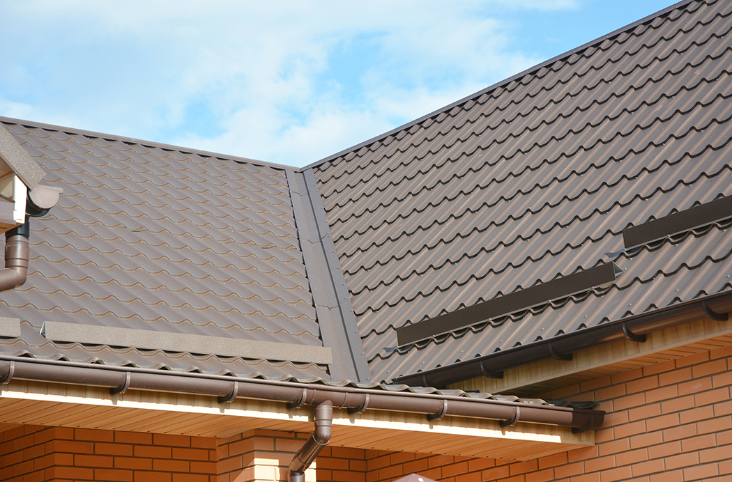 Brick house with light brown metal roofing