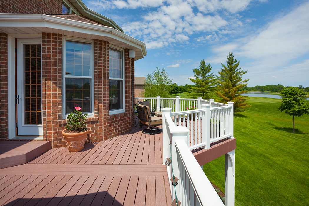 Home with a red deck with white vinyl railings